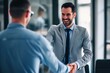 © Sardar - Smiling middle aged business man handshaking partner making partnership collaboration agreement at office meeting, hr manager and new worker shake hands recruiting at job interview. Welcome onboarding