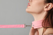 © Pixel-Shot - Young woman in pink collar on light background, closeup. Sex concept