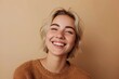 Smiling pretty gen z blonde young woman, cute happy 20s european student girl with short blond hair and white dental smile looking at camera standing isolated on beige background, portrait