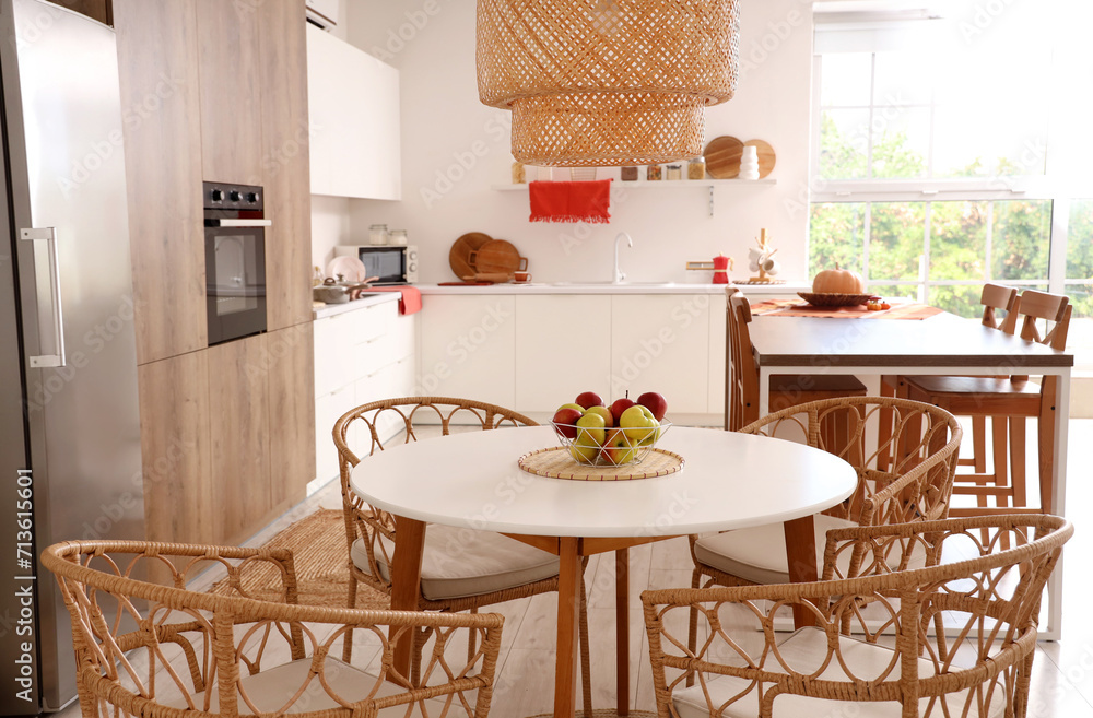 Basket with apples on dining table in modern kitchen