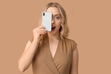 Sticker - Pretty young woman with modern smartphone on beige background