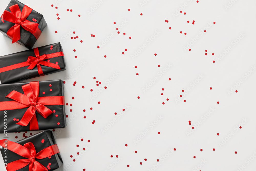 Gift boxes and confetti on white background. Black Friday