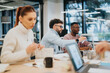 © qunica.com - Diverse business team collaborating, discussing marketing strategies, reviewing statistics, and planning tasks for financial growth.