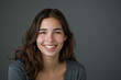 © MagnusCort - A woman with long brown hair is smiling and wearing a grey shirt