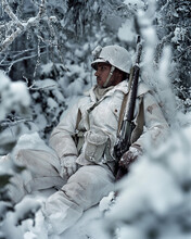 Soldier In The Snow And Camouflaged, Videogame Visual Concept Render. Gillie Suit Blended In Snow And Winter Landscape