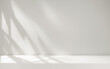 © Celt Studio - Blurred shadow from palm leaves on neutral wall. Minimal abstract background for product presentation. Minimal abstract light grey backdrop