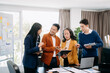 © Nuttapong punna - Happy businesspeople while collaborating on a new project in an office. Group of diverse businesspeople