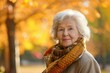 © Lucija - Beautiful senior woman in coat, enjoying autumn, park setting