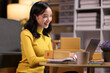 © Kainnika - A young Asian woman started an online sales business as a part-time job, She is working with shipping boxes to prepare for home delivery of an internet order.