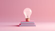 mock up of stacked pink book and light bulb in minimal design on pink background