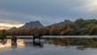 © htrnr - Sunset reflections on Sorrel chestnut wild horse stallion grazing on eel grass in the Salt River near Mesa Arizona United States
