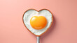 heart shape of fried egg on a frying pan valentine concept