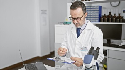 Poster - Confident middle age man with grey hair, smiling in his lab coat, meticulously takes notes on clipboard amidst a bustling laboratory