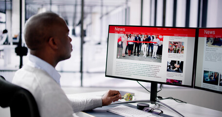 Reading News Article Headline On Laptop