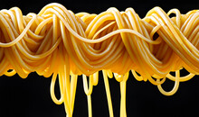 Yellow Noodles Drenched In Soup Float Deliciously On A Black Background.