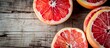An enticing array of vibrant citrus fruits, including tangy oranges and zesty lemons, are displayed on a rustic wooden surface, evoking thoughts of natural foods, superfoods, and a healthy diet