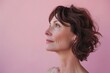 © Lazylizard - A confident mature woman with naturally gray hair looks away thoughtfully, standing against a vibrant pink background..