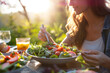 © Patcharaphon - Happy vegeterian woman eating salad in the garden at home. Vegan, healthy lifestyle concept