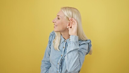 Poster - Blonde beauty in denim shirt, ears perked, soaking in juicy rumors, a playful take on deafness. a vivid yellow backdrop isolates her intrigue.