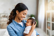 © Marko - Joyful New Mother Holding Newborn