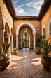 Spanish hacienda-style estate courtyard with stucco archways, wrought iron lighting, potted plants, a tile fountain, and wooden doorways.
