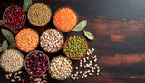 Fototapeta  - Top view of various bowls of legumes of various types and colors on a dark wooden kitchen table. Healthy food concept and detox or vegan menu. World Pulses Day.