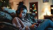 Teenage female in headphones using smartphone at home