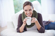 © Nicola Katie/peopleimages.com - Coffee, thinking and happy woman relax on a sofa with memory, moment or reflection in her home. Tea, break and female person in a living room with comfort, beverage or day off, me time or self care