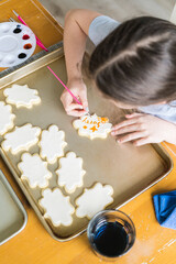 Wall Mural - Little Girl Spells 'Sorry' on Iced Sugar Cookies