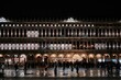Night view of square San Marco in Venice with people, restaurants and illuminated facade, Venice, Italy