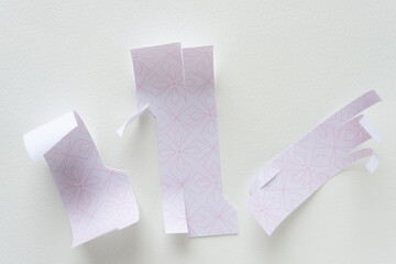 Sticker - torn paper pieces with curled edges and geometric pattern in pink