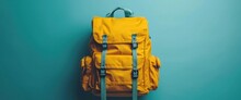 Yellow Schoolbag With School Supplies On A Blue Background