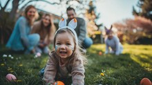 Family Enjoying An Easter Egg Hunt In The Backyard With A Child Wearing Bunny Ears.