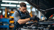 © john - Attractive confident male auto mechanic working in Car Service