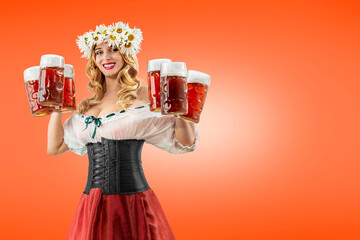 Wall Mural - Midsummer woman waitress serving big beer mugs on orange isolated background. Blonde girl with wreath daisies flowers in her hair celebrating traditional beer festival in summer or spring