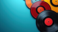  A Group Of Different Colored Records Sitting On Top Of A Blue Surface With Black And Orange Discs In The Middle Of The Album, With A Single Disc In The Middle Of The.