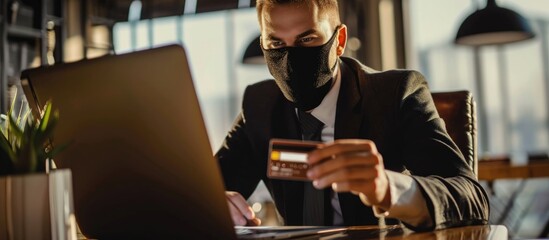 Wall Mural - Masked businessman using credit card online