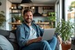 © Nuttakarn - Smiling Man Using Laptop in Cozy Living Room