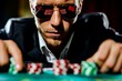 © apratim - Intense male poker player with sunglasses at a casino table betting with chips, focused and serious about the game.