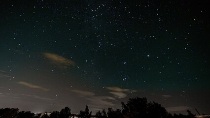 Sticker - Milky way galaxy stars night sky over forest Time lapse