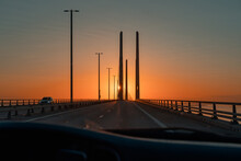 Driving On Oresund Bridge 'Øresundsbron' At Sunset. View From The Passenger Seat. Crossing The Border Between Sweden And Denmark By Car.