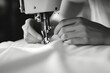 A person operating a sewing machine. Suitable for illustrating sewing, fashion, or textile industries