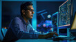 © MP Studio - Focused male programmer working in a dark office environment, typing intently on a keyboard while multiple monitors display lines of code