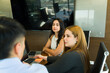 © AntonioDiaz - Point of view of a businessman talking to a couple of businesswomen during a business meeting