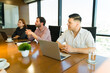 © AntonioDiaz - Businessmen in casual clothing paying attention to a business presentation in a meeting room