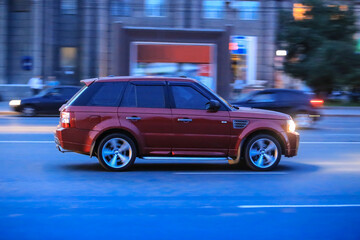 Wall Mural - suv driving down the street at night