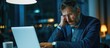© The 2R Artificiality - Anxious businessman at work observing ransomware on laptop screen.