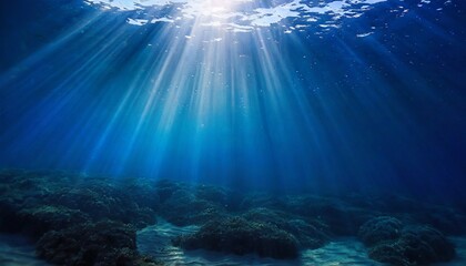 abstract image of tropical underwater dark blue deep ocean wide nature background with rays of sunli