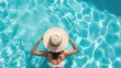 © buraratn - Top view of beautiful woman earing sunhat relaxing in swimming pool