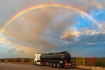 Canvas Print - Tanker truck with dangerous goods parked under a spectacular sky with rainbow.